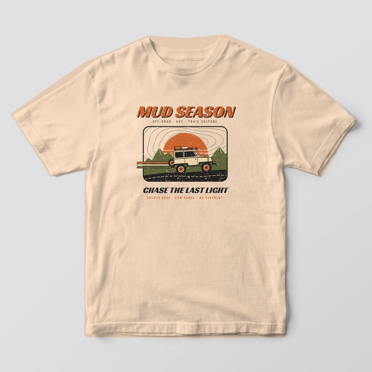 Front of an ivory Comfort Colors 1717 T-shirt with a full-front print of a lifted 4x4 climbing a ridge at sunset under Mud Season racing lettering.