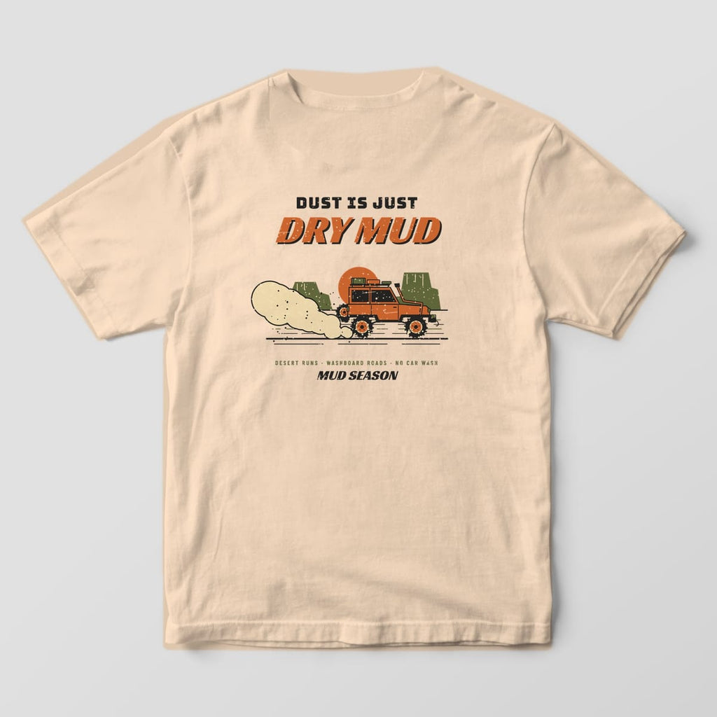 Back of an ivory Comfort Colors 1717 T-shirt printed with a lifted 4x4 trailing a dust cloud past desert buttes and Dust Is Just Dry Mud lettering.