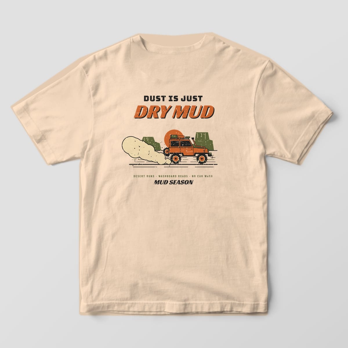 Back of an ivory Comfort Colors 1717 T-shirt printed with a lifted 4x4 trailing a dust cloud past desert buttes and Dust Is Just Dry Mud lettering.