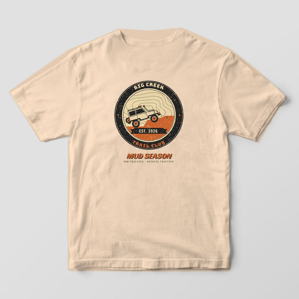 Back of an ivory Comfort Colors 1717 T-shirt printed with a Big Creek Trail Club circle badge, a climbing 4x4 and an EST. 2026 ribbon.