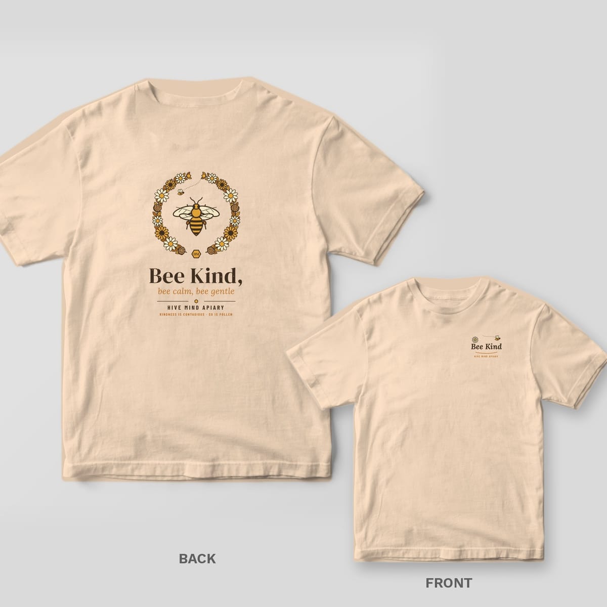 Back and front of a ivory Comfort Colors T-shirt; the back shows a honey bee inside a wildflower wreath above the words Bee Kind, bee calm, bee gentle, the front has a small left-chest print.