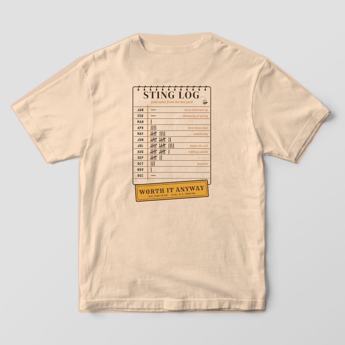 Back of a ivory Comfort Colors 1717 T-shirt printed with a notebook sting log with monthly tally marks and a Worth It Anyway stamp.