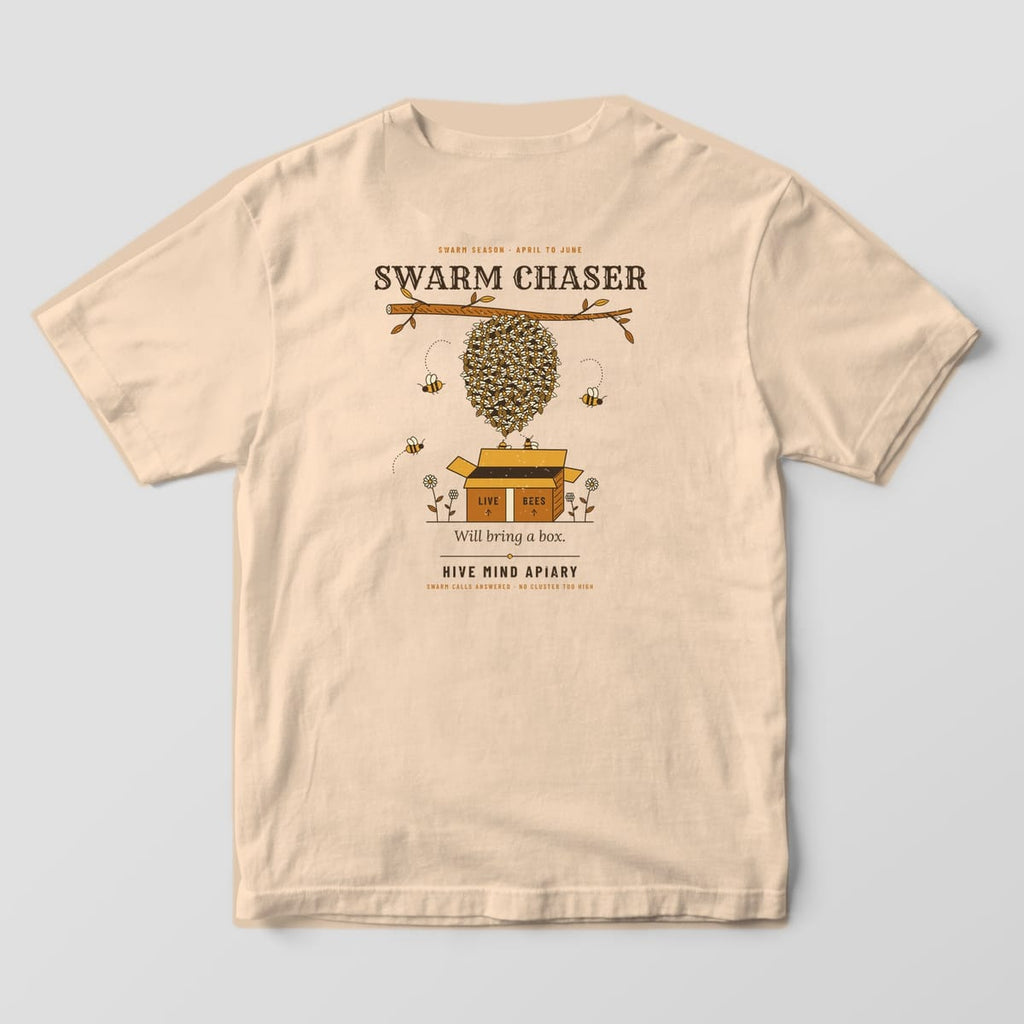 Back of an ivory Comfort Colors 1717 T-shirt printed with a swarm of bees hanging from a branch above an open cardboard box, titled Swarm Chaser.