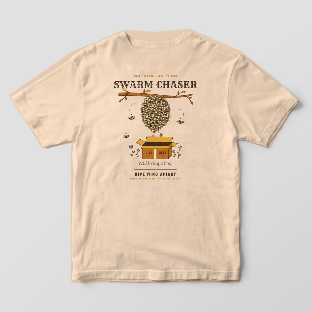 Back of an ivory Comfort Colors 1717 T-shirt printed with a swarm of bees hanging from a branch above an open cardboard box, titled Swarm Chaser.