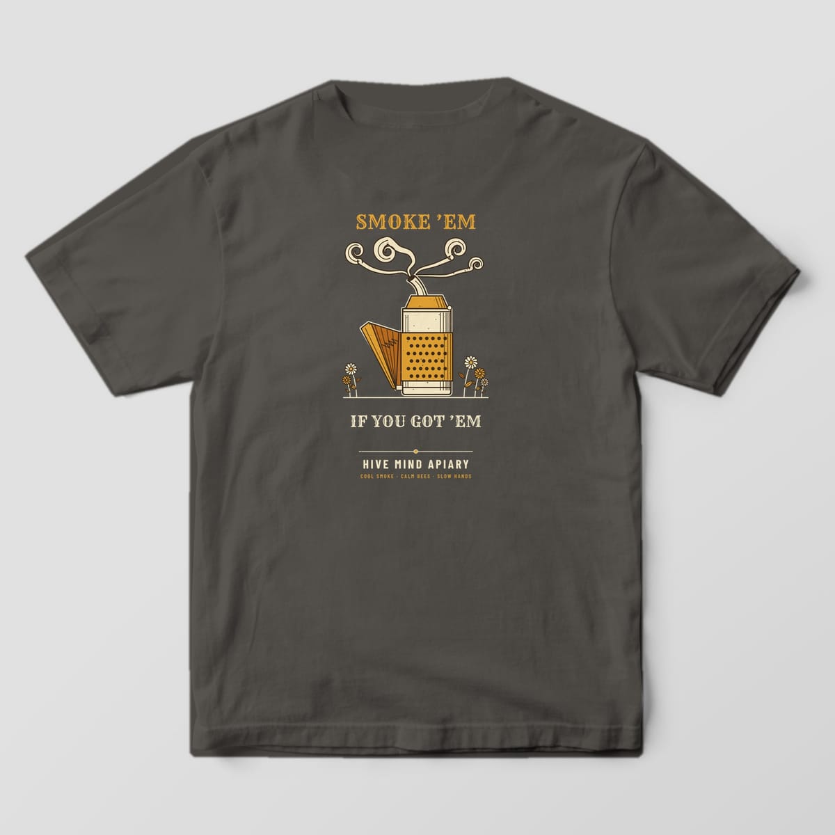 Back of a pepper Comfort Colors 1717 T-shirt printed with an engraved bee smoker with curling smoke and the words Smoke 'Em If You Got 'Em.