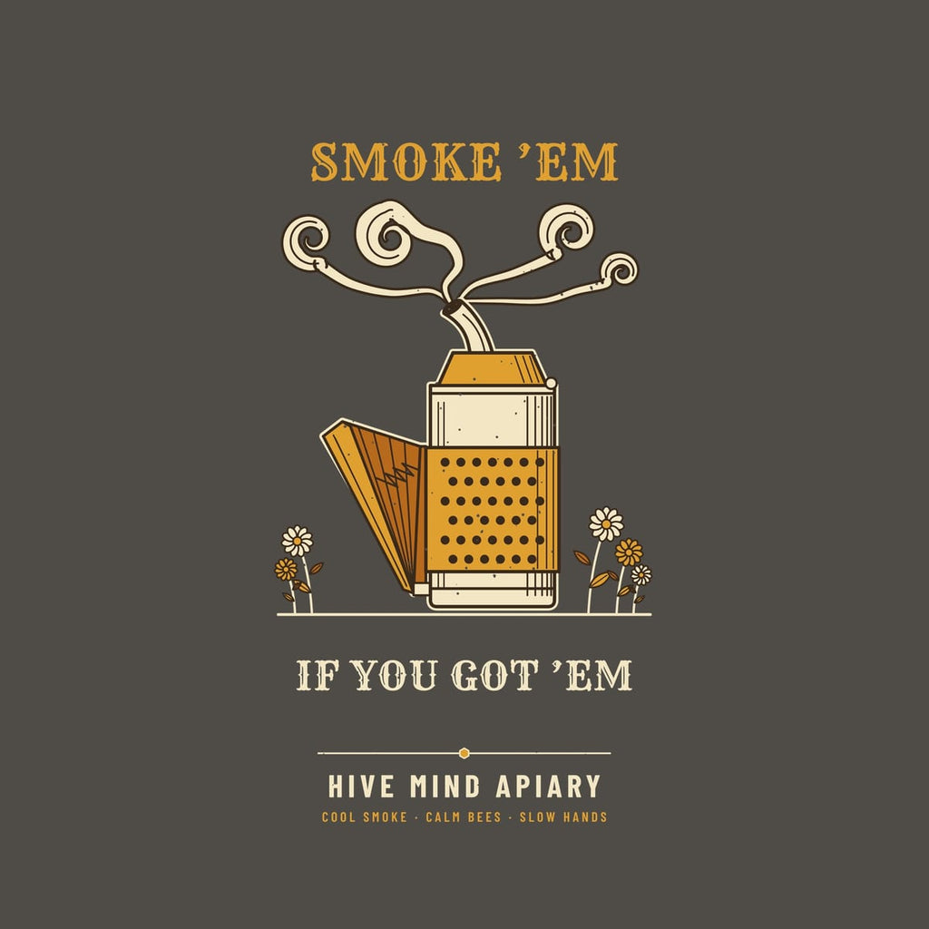 Close-up of the full back artwork: an engraved bee smoker with curling smoke and the words Smoke 'Em If You Got 'Em, shown flat on a pepper background.
