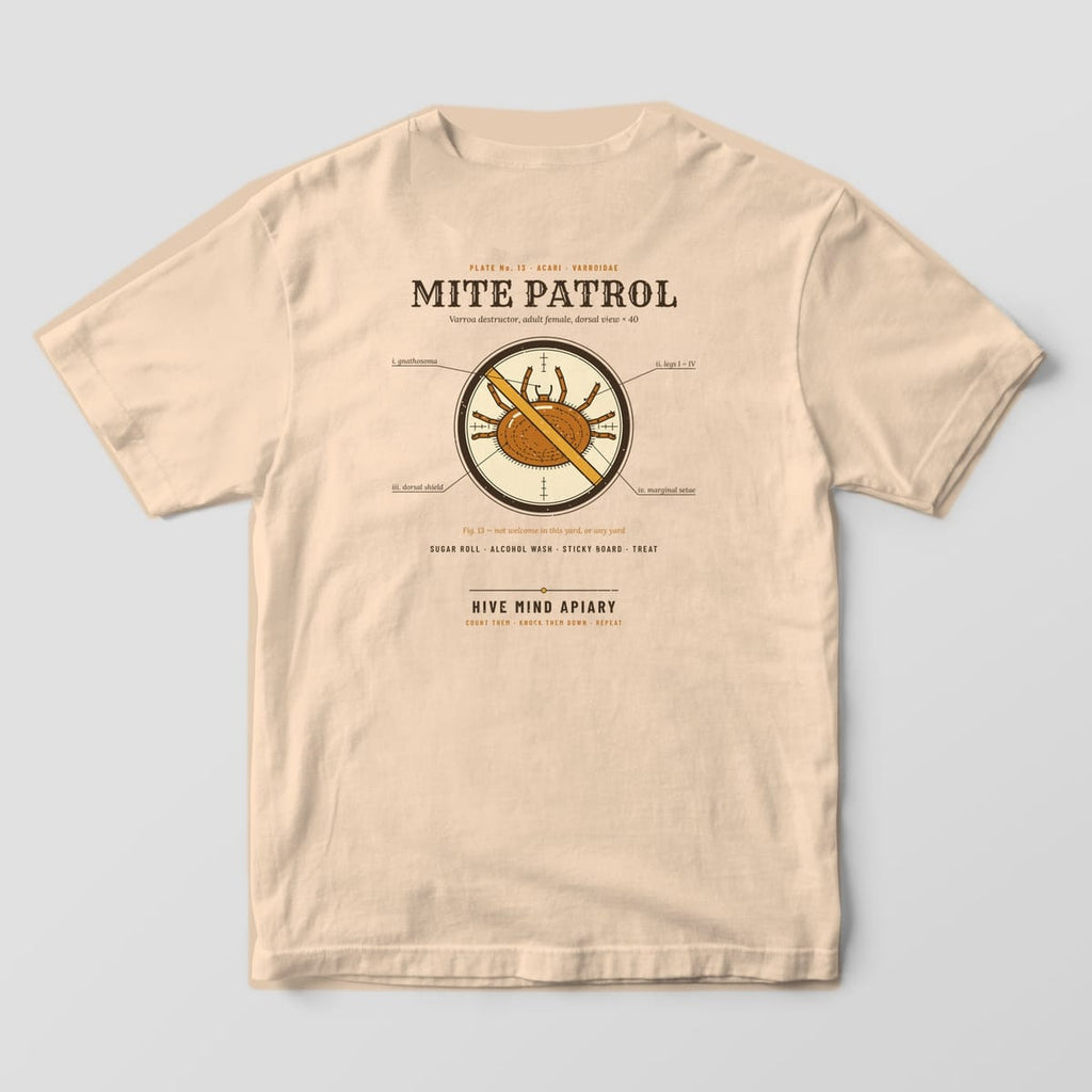 Back of an ivory Comfort Colors 1717 T-shirt printed with a labeled Varroa mite in a microscope circle crossed out with a gold slash, titled Mite Patrol.