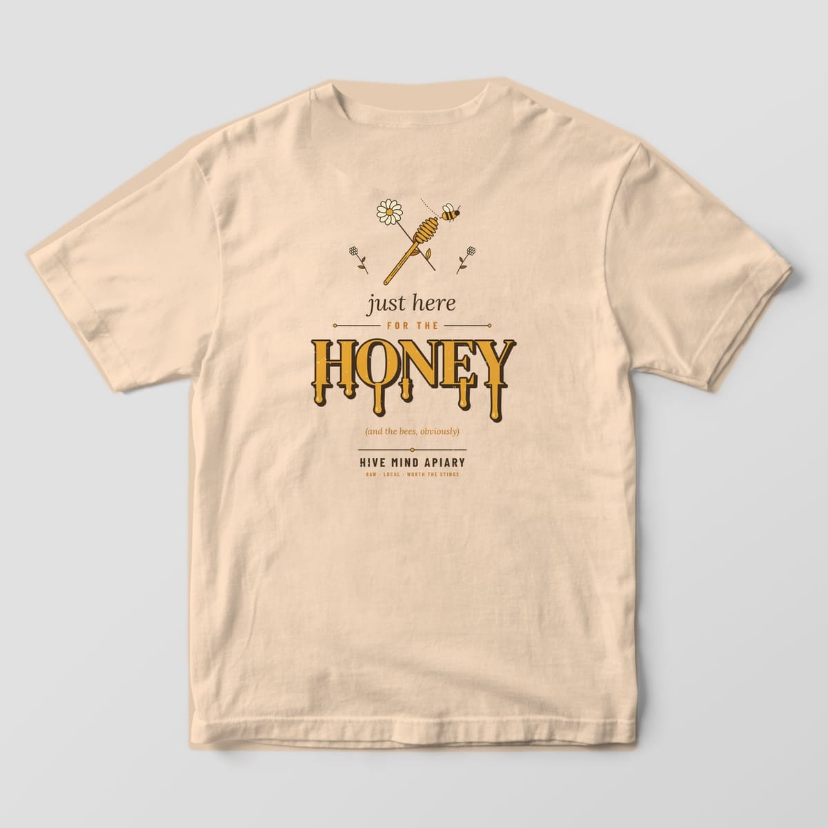 Back of an ivory Comfort Colors 1717 T-shirt printed with dripping gold lettering reading just here for the HONEY under a honey dipper and daisy.