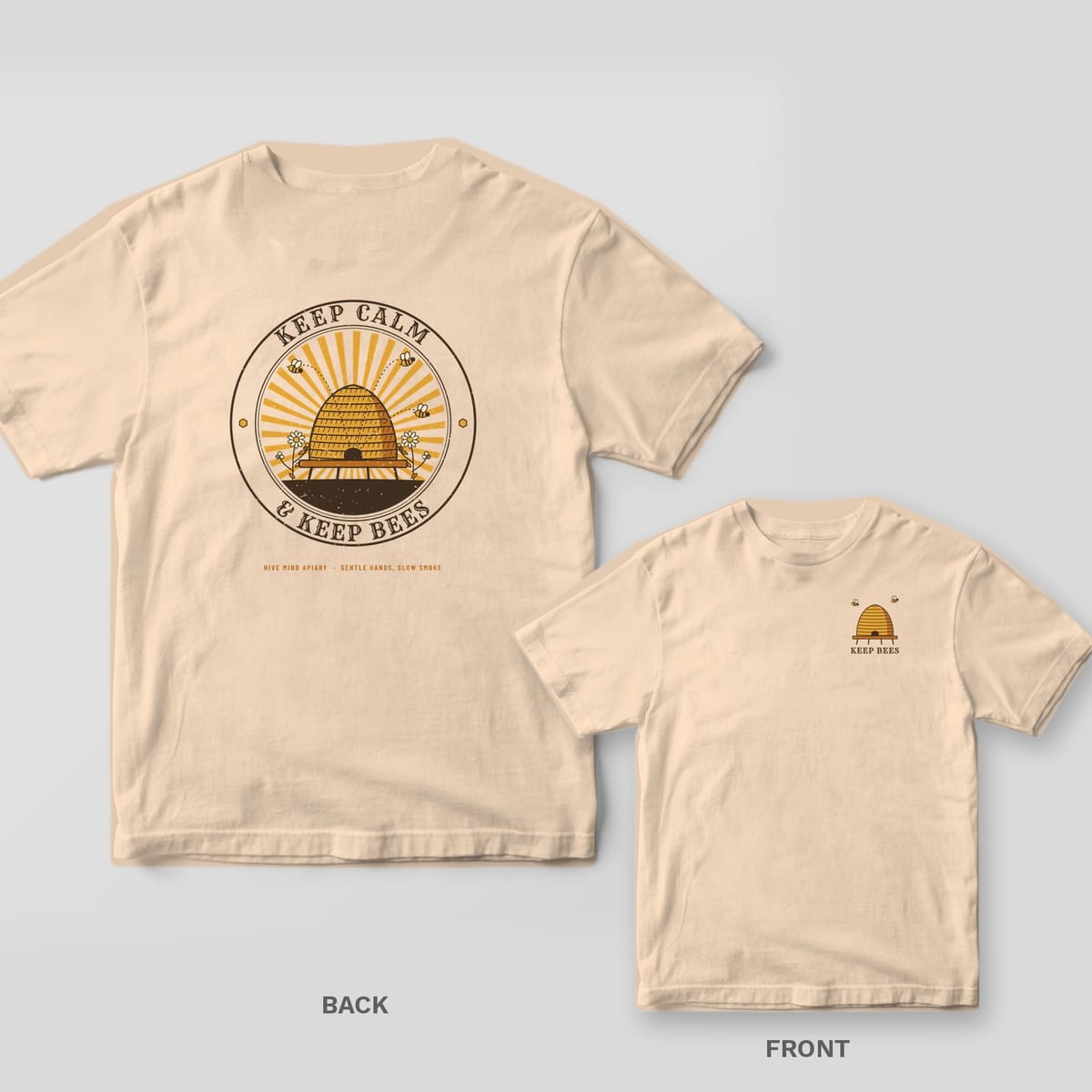Back and front of a ivory Comfort Colors T-shirt; the back shows a straw beehive skep in a sunburst badge with Keep Calm and Keep Bees lettering, the front has a small left-chest print.