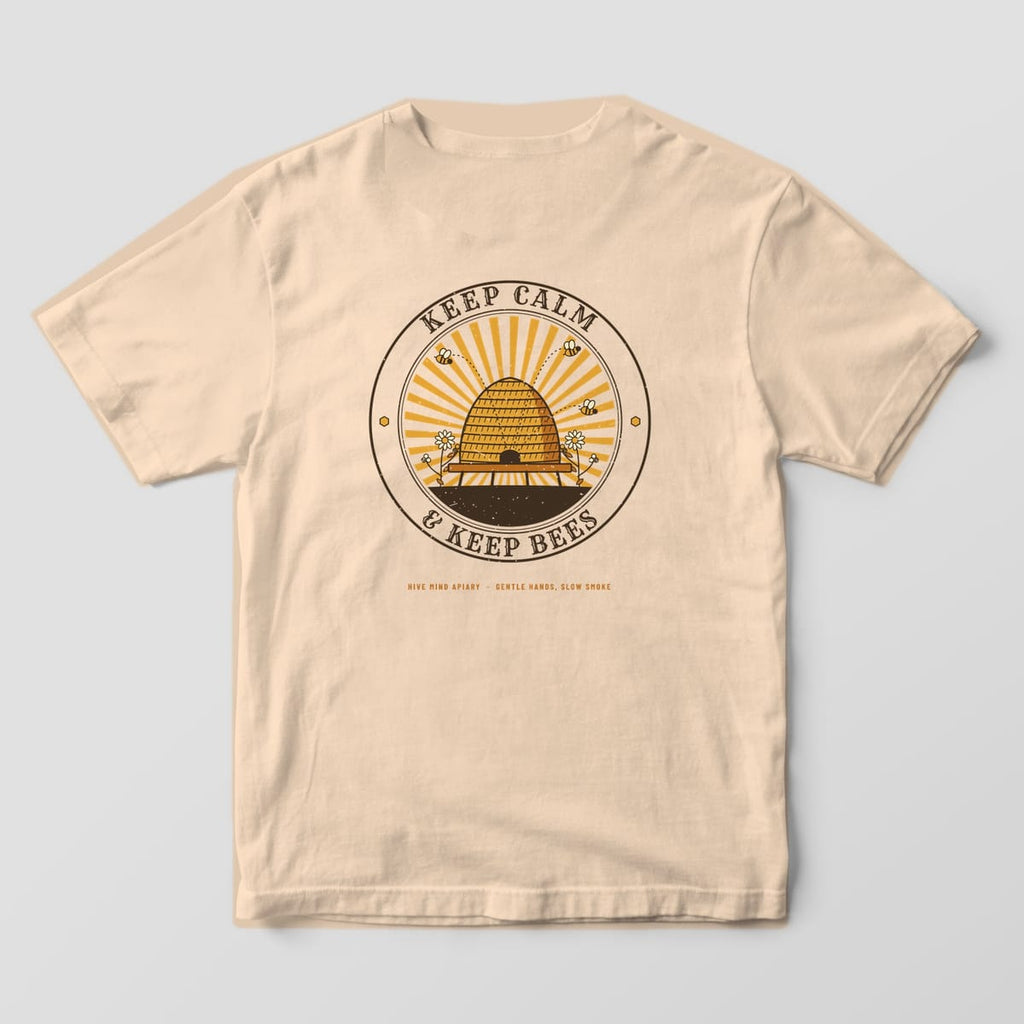 Back of a ivory Comfort Colors 1717 T-shirt printed with a straw beehive skep in a sunburst badge with Keep Calm and Keep Bees lettering.
