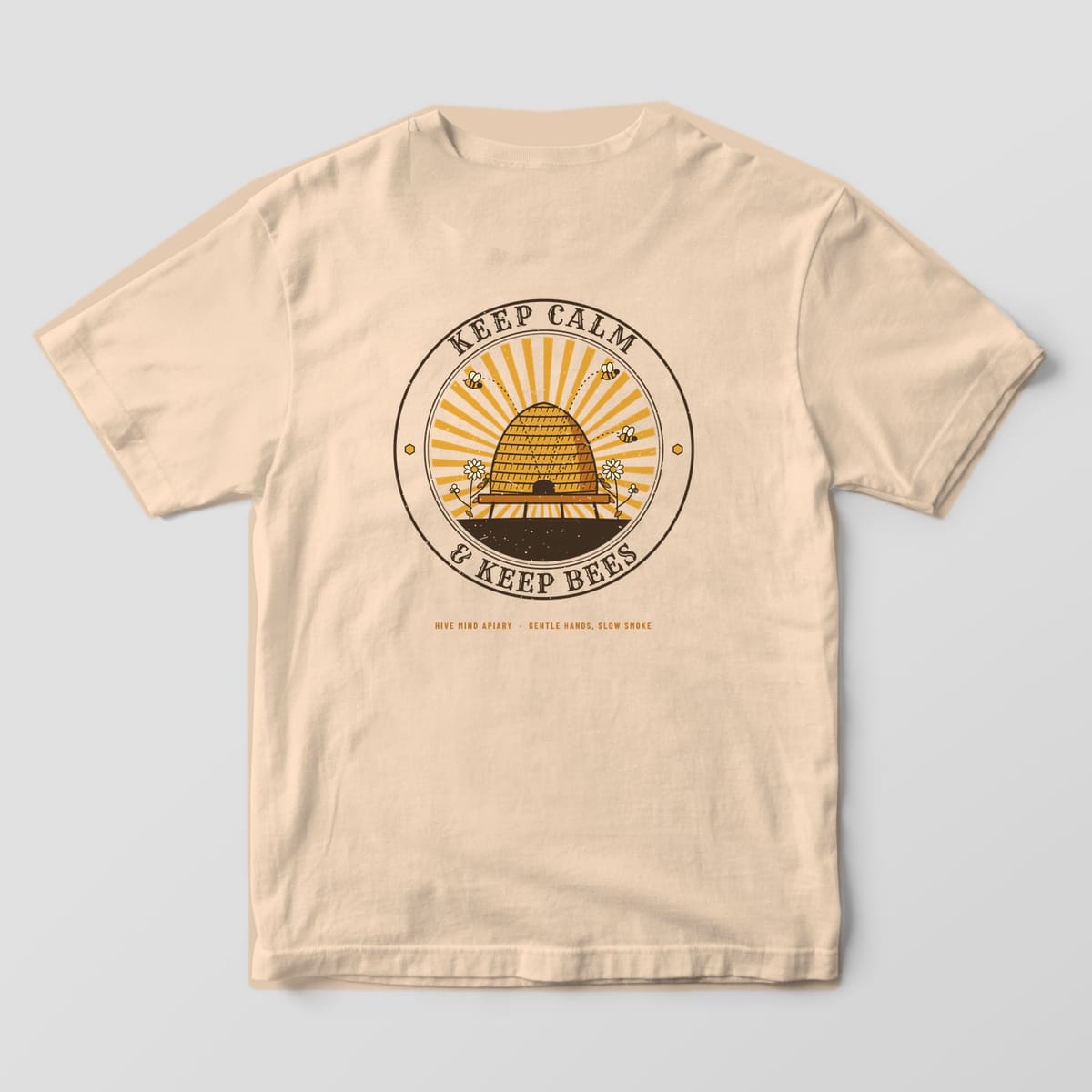 Back of a ivory Comfort Colors 1717 T-shirt printed with a straw beehive skep in a sunburst badge with Keep Calm and Keep Bees lettering.