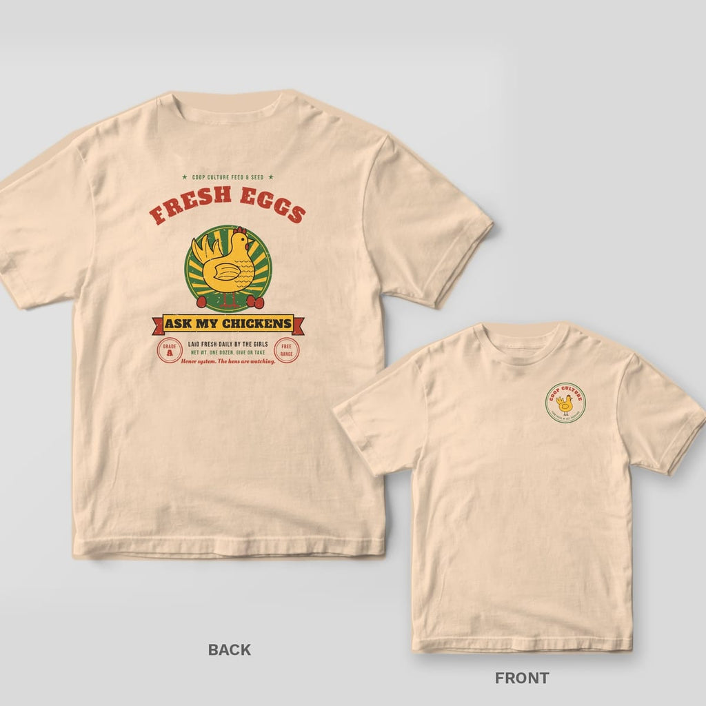 Ivory Comfort Colors tee shown back and front: back has a retro Fresh Eggs Ask My Chickens feed-sack print with a yellow hen; front has a small Coop Culture hen badge.