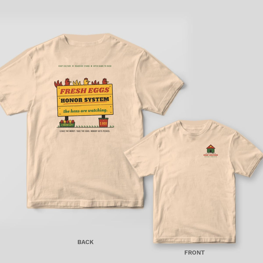 Ivory tee shown back and front: back has a yellow Fresh Eggs Honor System farm stand sign with hens peeking over it; front has a small green chicken coop.