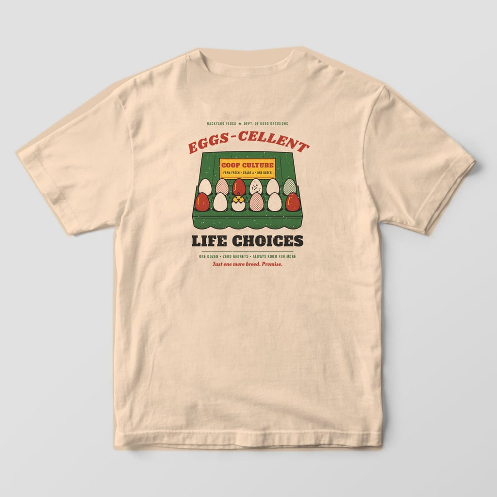 Back of an ivory Comfort Colors 1717 tee with a green egg carton full of colorful eggs and a hatching chick under the words Eggs-cellent Life Choices.