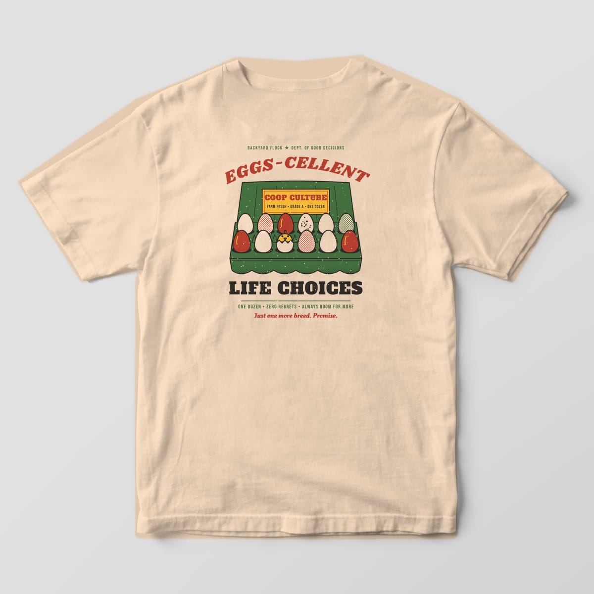Back of an ivory Comfort Colors 1717 tee with a green egg carton full of colorful eggs and a hatching chick under the words Eggs-cellent Life Choices.
