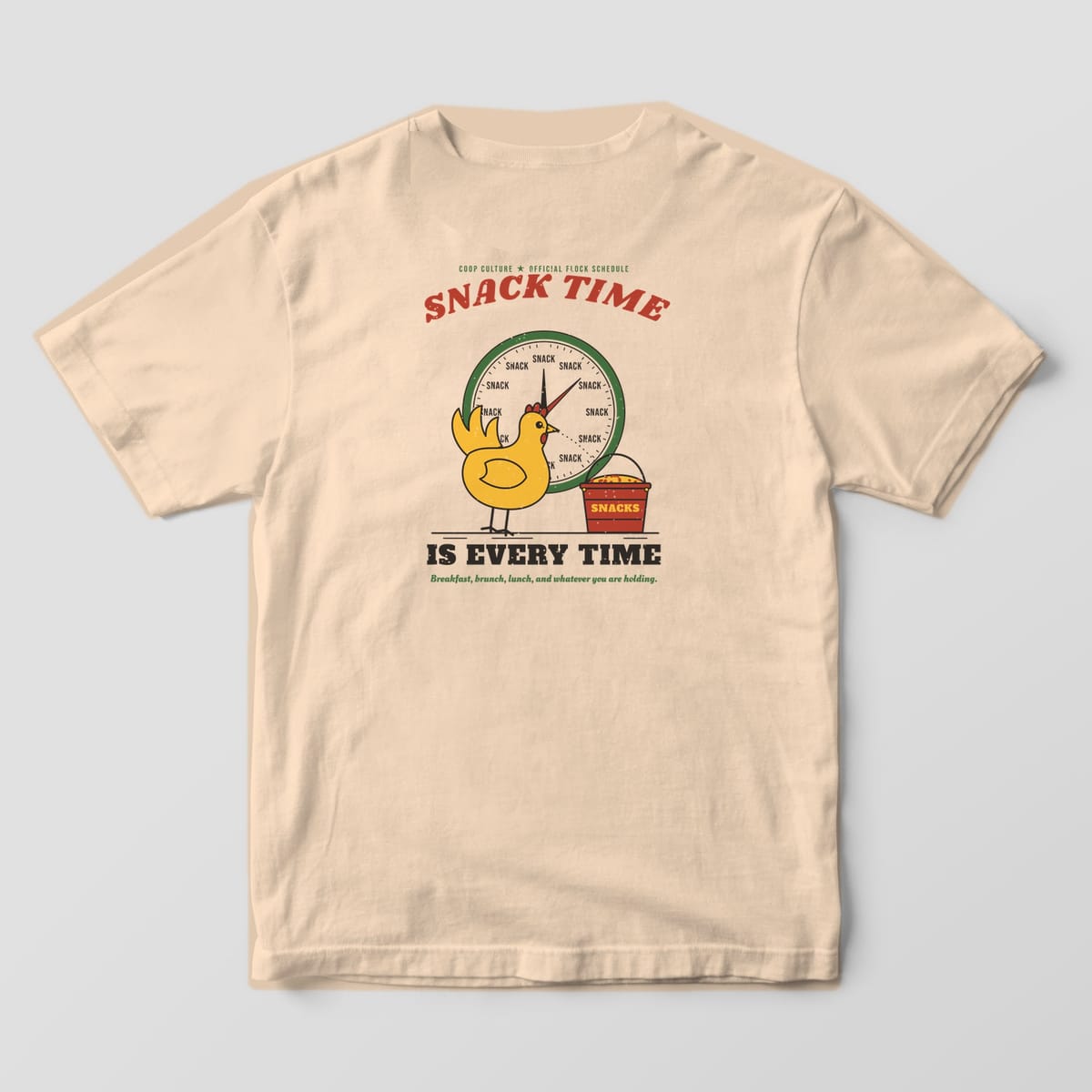 Back of an ivory Comfort Colors 1717 tee with a yellow hen staring at a red snack bucket in front of a clock where every hour says snack.