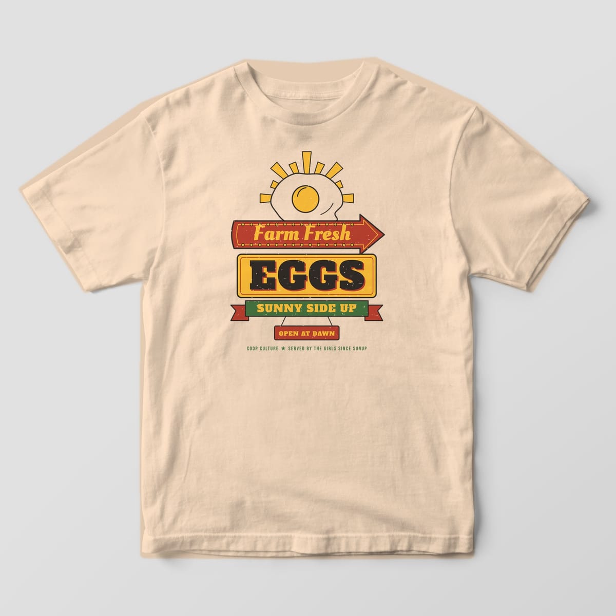 Front of an ivory Comfort Colors 1717 tee with the Farm Fresh Eggs Sunny Side Up diner sign printed across the chest.