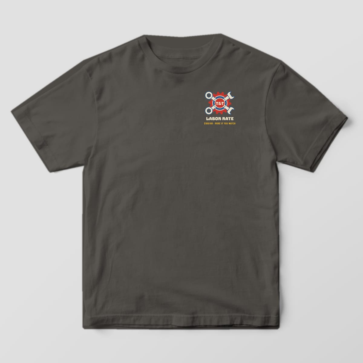 Front of a Pepper Comfort Colors 1717 tee with a small crossed-wrench gear crest above the words Labor Rate on the left chest.