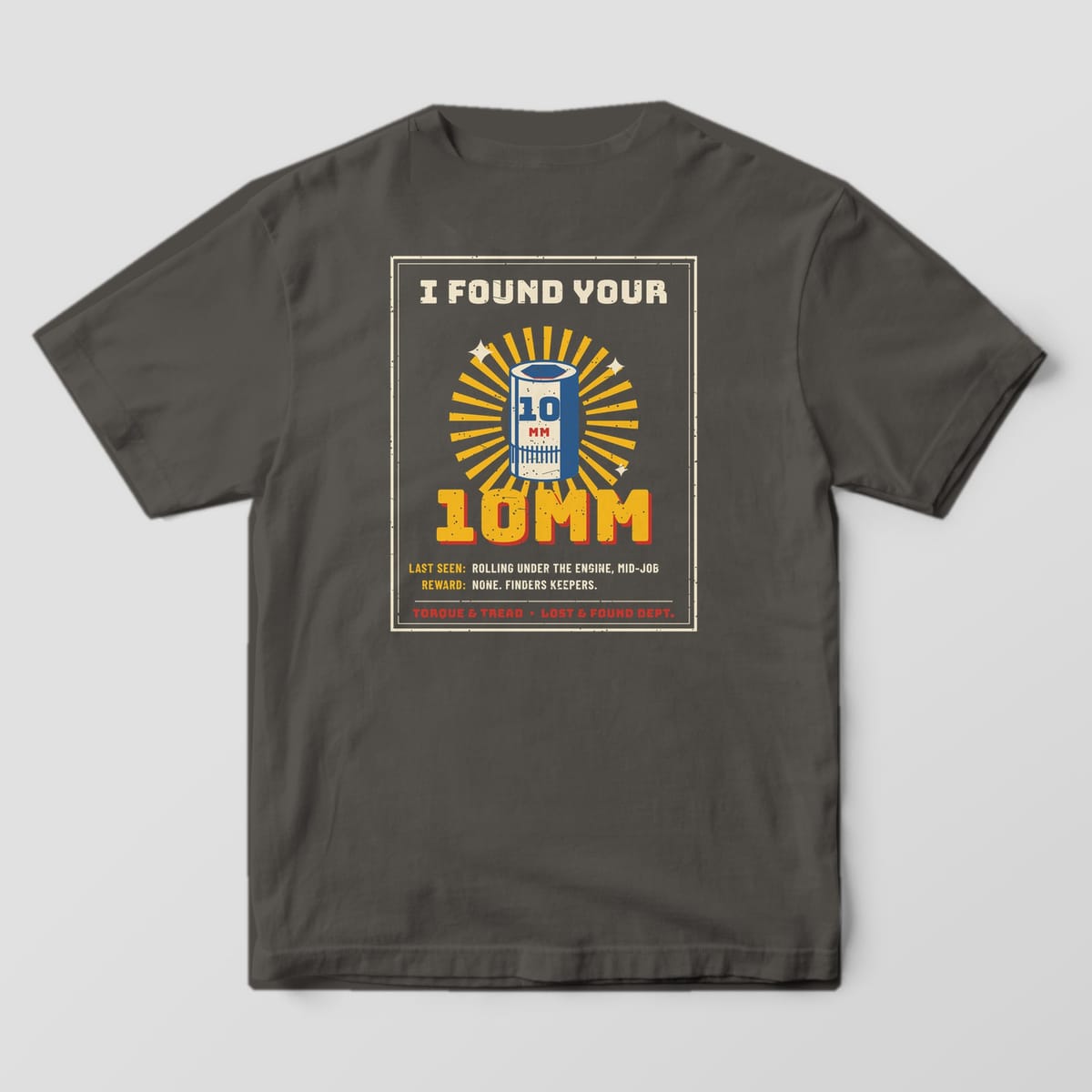 Back of a Pepper Comfort Colors 1717 tee with the cream-framed poster reading I Found Your 10mm with a blue and cream socket glowing in yellow rays.