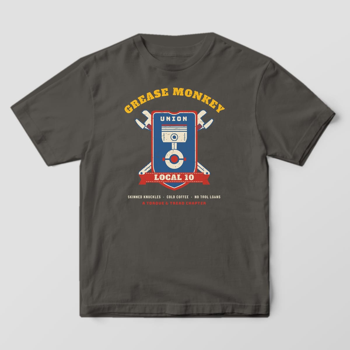 Front of a Pepper Comfort Colors 1717 tee with the full-front Grease Monkey Union Local 10 crest.