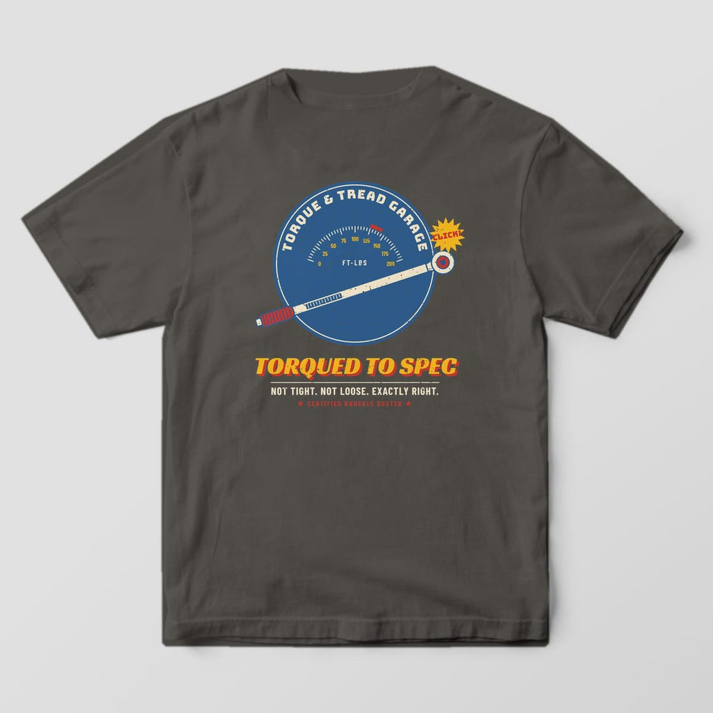 Back of a Pepper Comfort Colors 1717 tee with the blue gauge dial with a ft-lbs scale and a cream torque wrench, a yellow Click burst and the words Torqued To Spec.