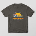 Front of a Pepper Comfort Colors tee with a full-front print of a retro service station at sunset with pumps, a tow truck and Torque & Tread lettering.