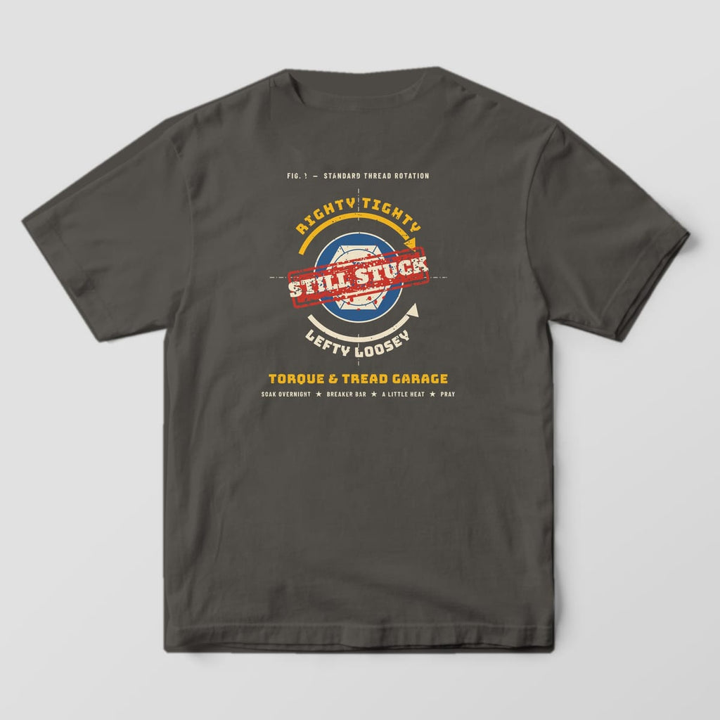 Back of a Pepper Comfort Colors 1717 tee with the shop-manual diagram of a rusty bolt head with Righty Tighty and Lefty Loosey arrows and a red Still Stuck stamp.