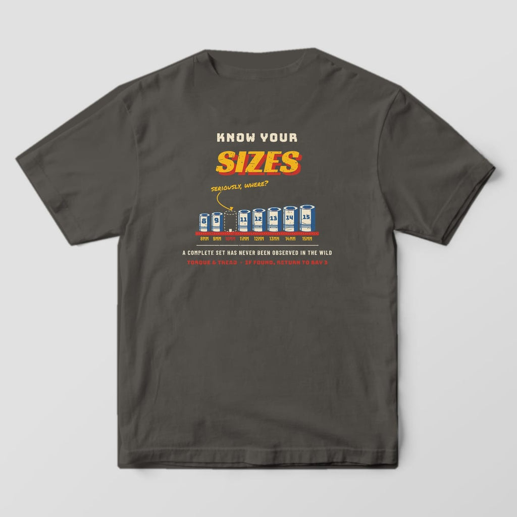 Back of a Pepper Comfort Colors 1717 tee with the row of chrome sockets from 8mm to 15mm on a red rail with the 10mm missing and a marker note asking seriously, where.