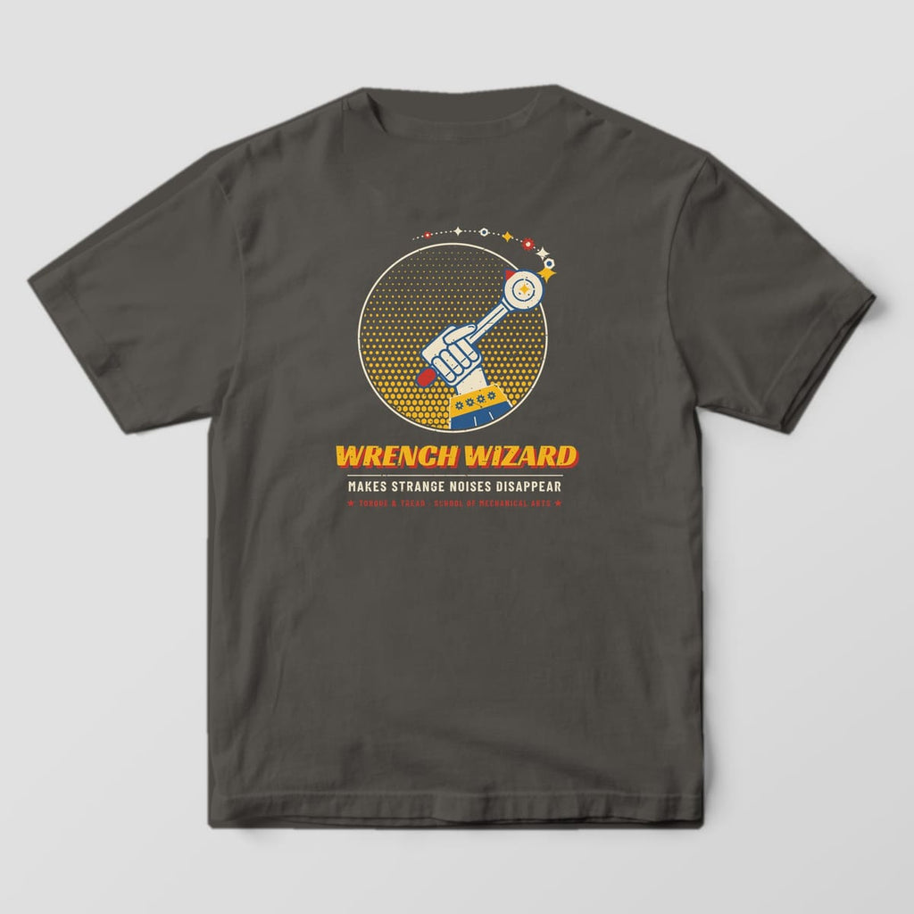 Back of a Pepper Comfort Colors 1717 tee with the hand in a wizard sleeve raising a ratchet like a wand with a trail of sparkles, nuts and gears over a yellow halftone circle and the words Wrench Wizard.