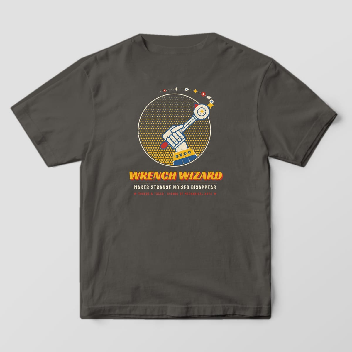 Back of a Pepper Comfort Colors 1717 tee with the hand in a wizard sleeve raising a ratchet like a wand with a trail of sparkles, nuts and gears over a yellow halftone circle and the words Wrench Wizard.