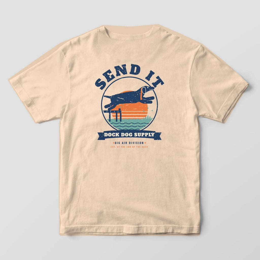 Back of an ivory Comfort Colors tee with a navy lab leaping off a dock across an orange sunset under arched Send It lettering