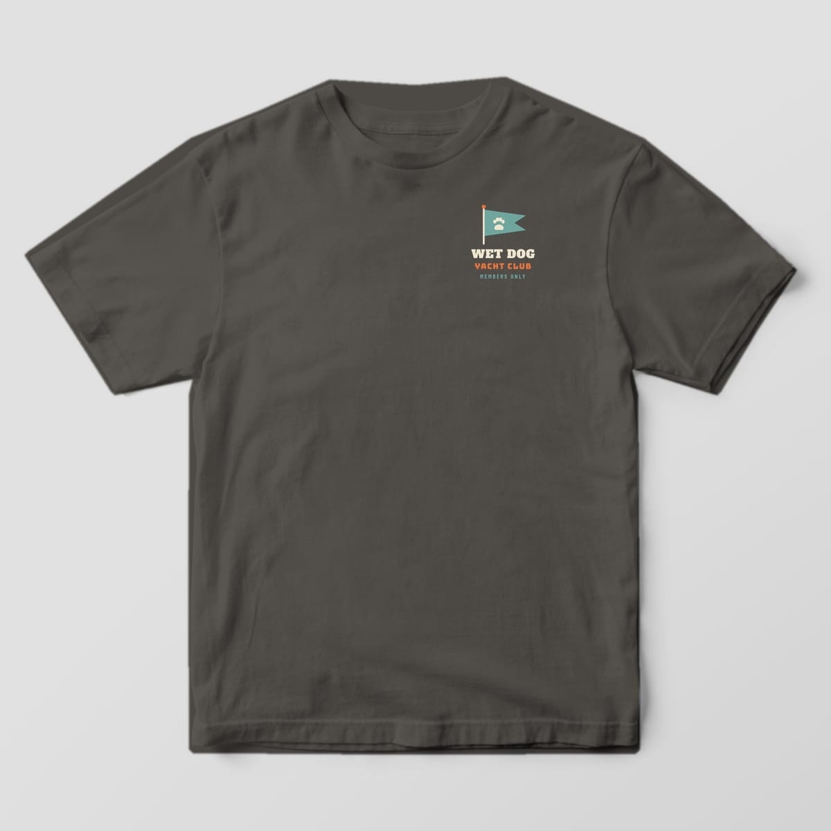 Front of a pepper Comfort Colors tee with a small teal paw pennant and Wet Dog Yacht Club text on the left chest