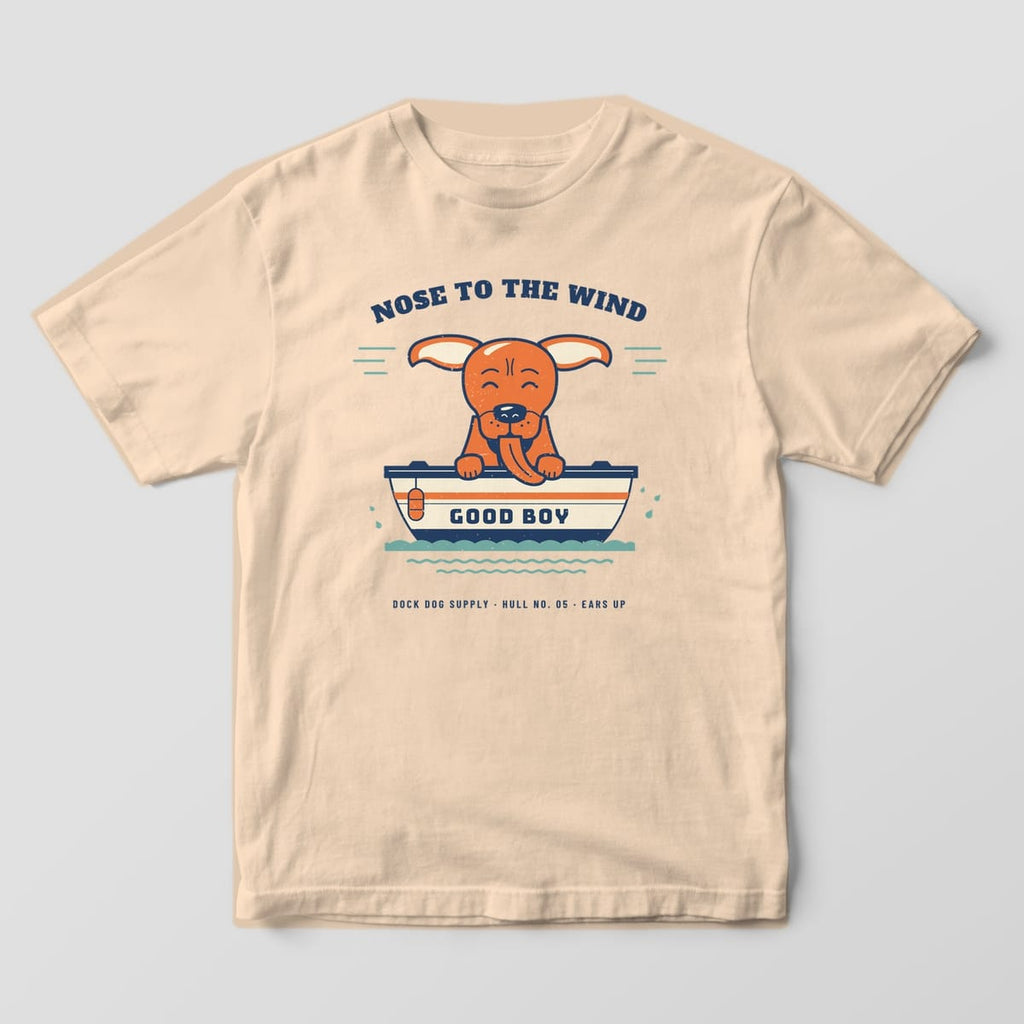 Ivory tee with a full-front print of a happy dog leaning over a boat rail, ears flapping, under Nose to the Wind