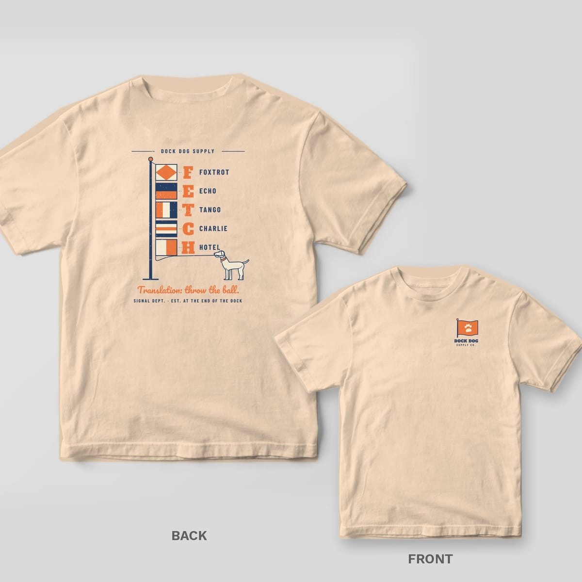 Ivory tee with nautical signal flags spelling FETCH and a lab pulling the halyard on the back, paw flag logo on the front chest