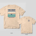Ivory tee with a tide chart back print where every high tide is labeled Swim Time and a black lab swims after a ball, cleat tag logo on the front chest