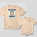 Ivory tee with a retro tackle-box label back print of a towel-wrapped lab and Premium Grade Wet Dog, Good Boy Marine Co. stamp on the front