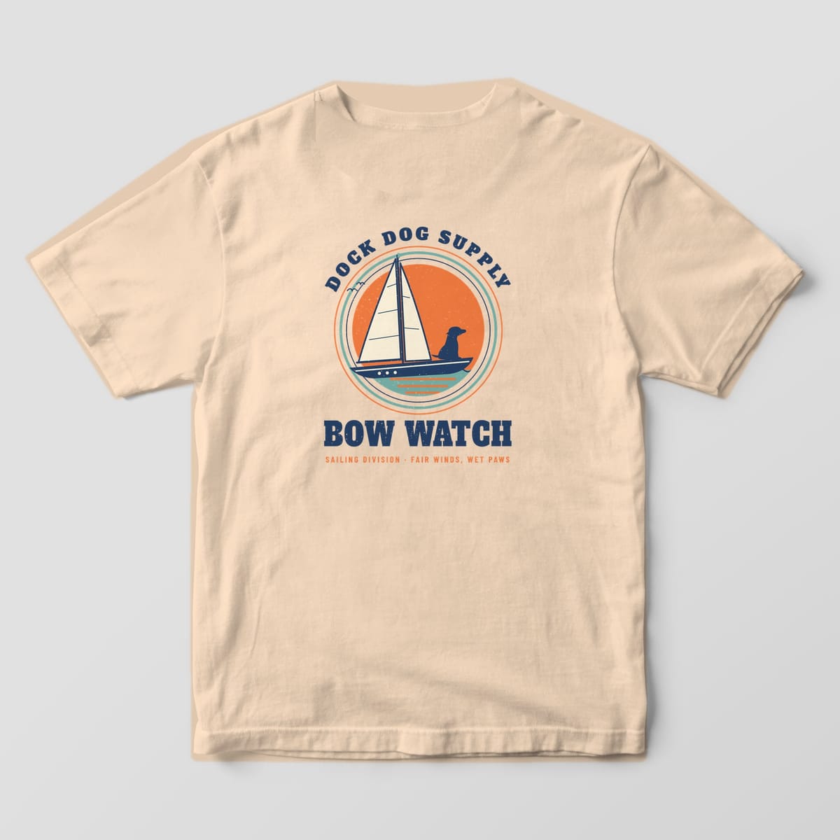 Back of an ivory Comfort Colors tee with a cream-sailed boat, dog silhouette at the bow and sunset rings, Bow Watch