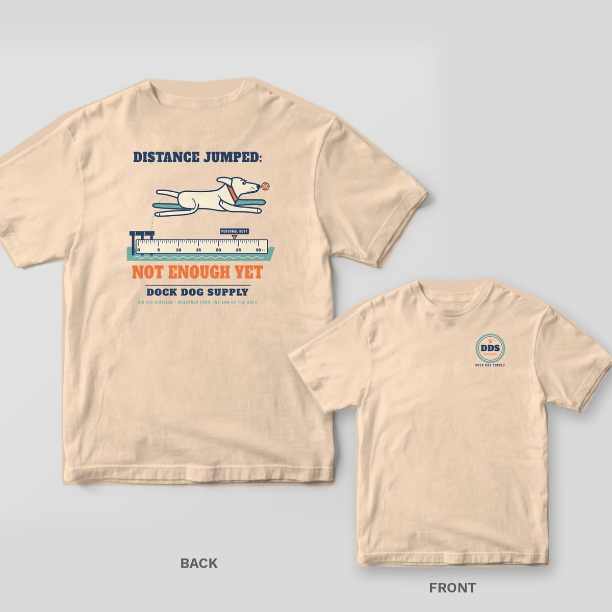 Ivory tee with a leaping lab over a 30 foot ruler and Distance Jumped: Not Enough Yet on the back, rope ring DDS logo on the front