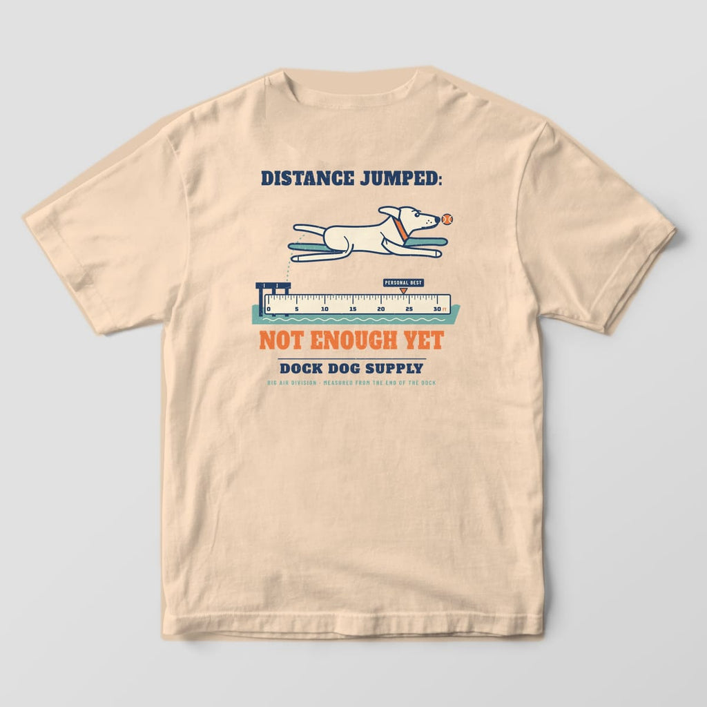 Back of an ivory Comfort Colors tee with a cream lab leaping off a dock over a ruler, Not Enough Yet in orange