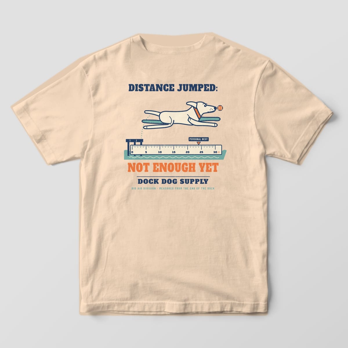 Back of an ivory Comfort Colors tee with a cream lab leaping off a dock over a ruler, Not Enough Yet in orange