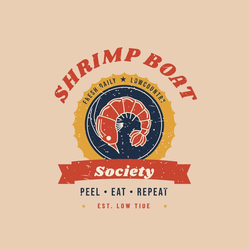 Close-up of the shack badge print: a curled red shrimp on navy in a scalloped gold seal, with speckled vintage texture.