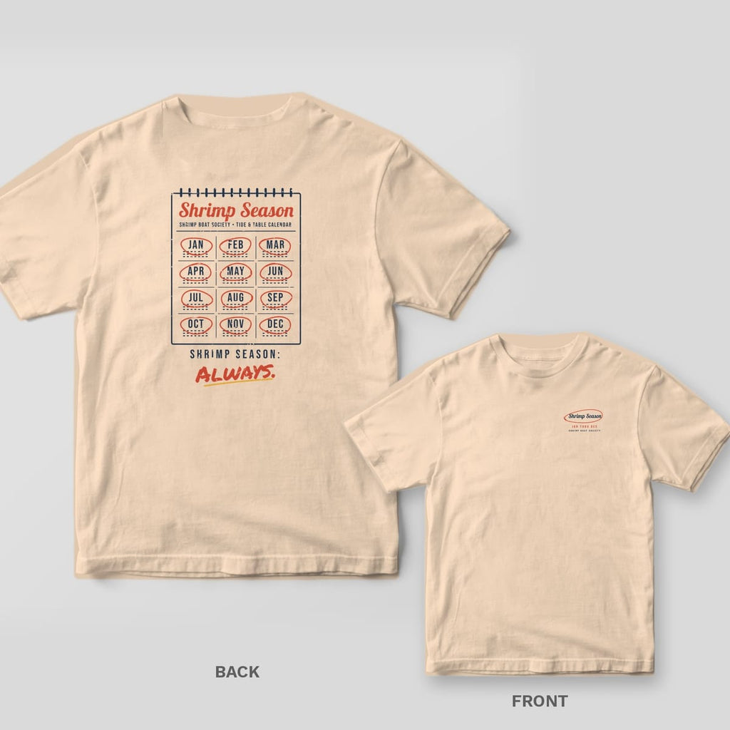 Ivory Comfort Colors tee shown back and front: a wall calendar with every month circled on the back and a circled Shrimp Season script on the left chest.