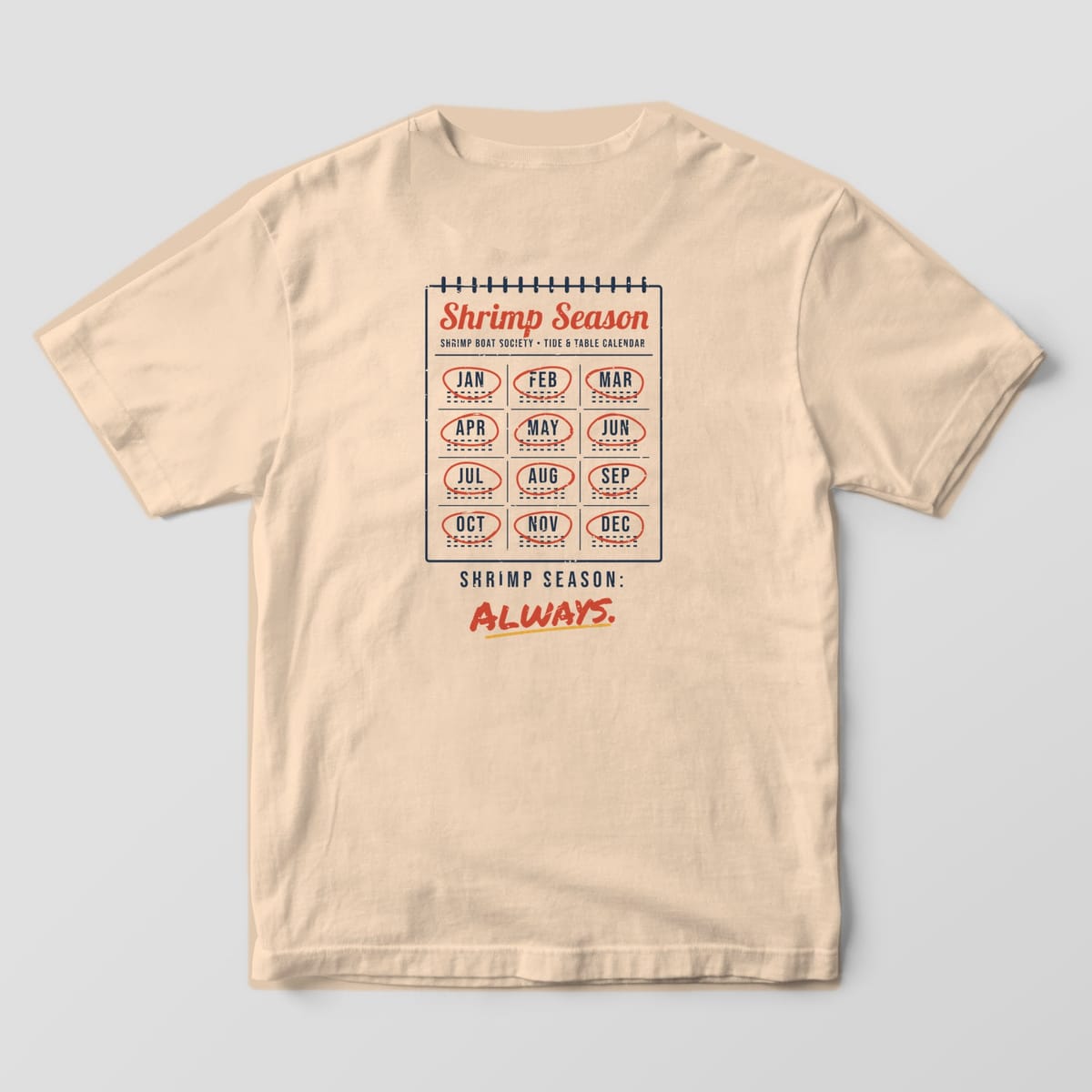 Back of an Ivory Comfort Colors 1717 tee with a navy spiral calendar, all twelve months circled in red, and the words Shrimp Season: Always.