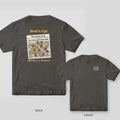 Pepper Comfort Colors tee shown back and front: an overhead shrimp boil spread on newspaper on the back and a small newspaper masthead text design on the left chest.