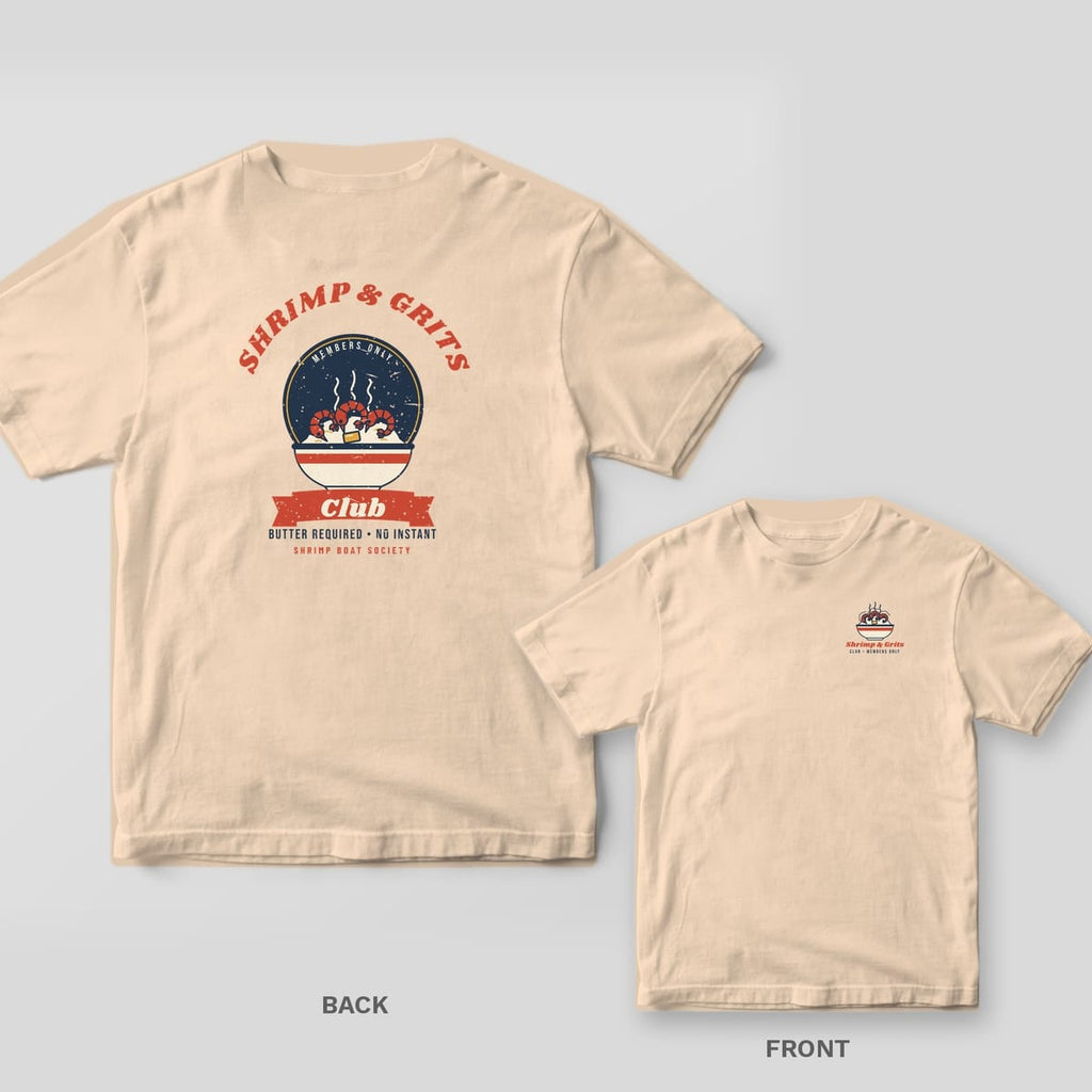 Ivory Comfort Colors tee back showing a navy diner badge with a bowl of shrimp and grits and a red Club banner, with the front pocket print inset