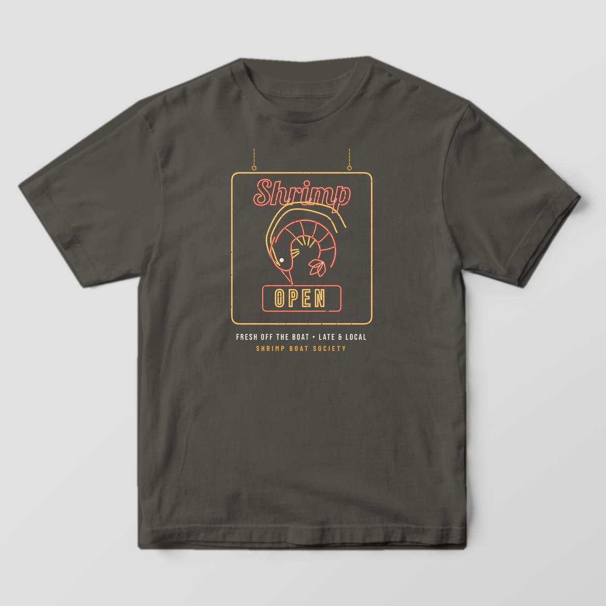 Front of a pepper Comfort Colors 1717 tee showing the neon shrimp sign print centered on the chest