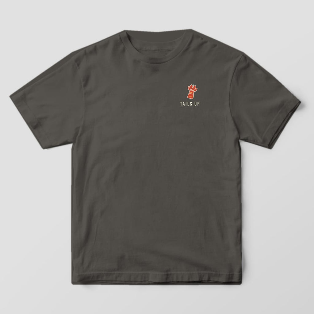 Front of a pepper Comfort Colors 1717 tee with a small shrimp tail and Tails Up text on the left chest