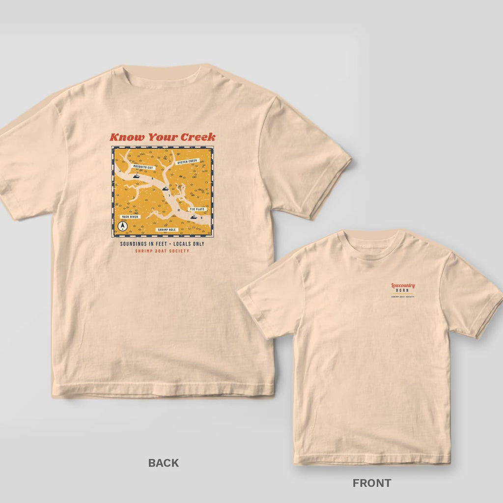 Ivory Comfort Colors tee back with a gold marsh map of winding creeks and Know Your Creek title, with the Lowcountry Born chest print inset