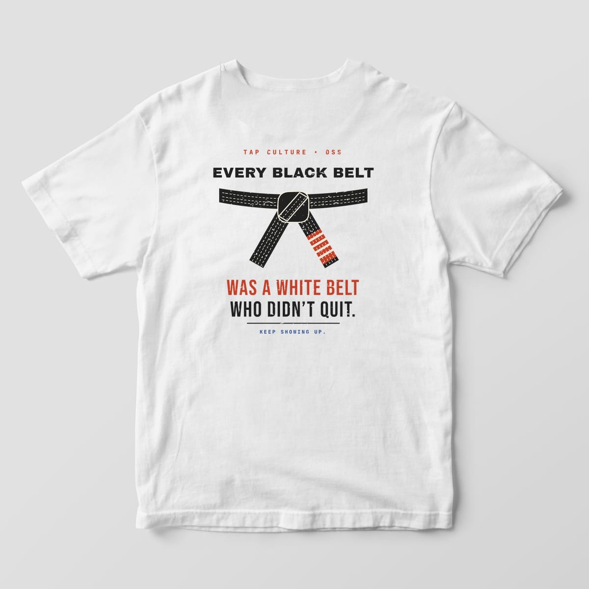 Back of a white Comfort Colors 1717 tee with a tied black belt and the quote in black and red lettering.