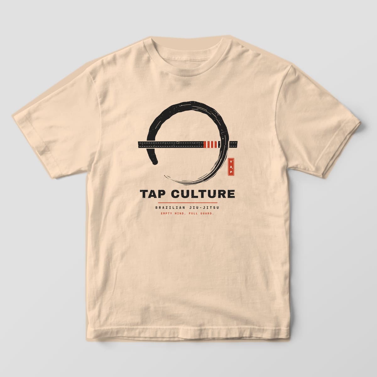 Front of an ivory Comfort Colors 1717 tee showing the enso and belt print centered on the chest.